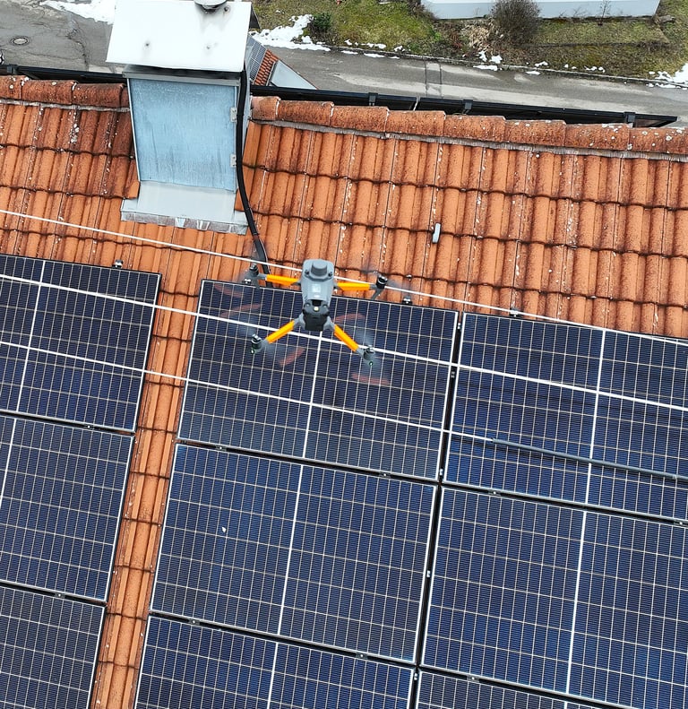 An industrial drone performs an automated thermal inspection of residential solar panels on a tile roof.