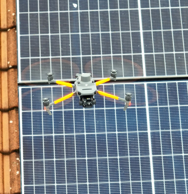 Professional inspection drone flying over residential solar panels for maintenance and thermal analysis.
