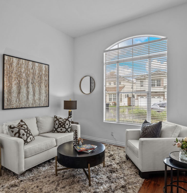 a staged living room with a couch and a table