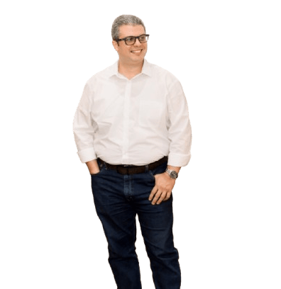 a man in a white shirt and jeans standing in front of a black background