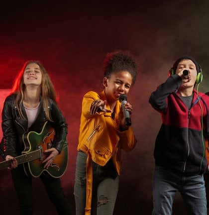 a group of kids singing and playing guitar