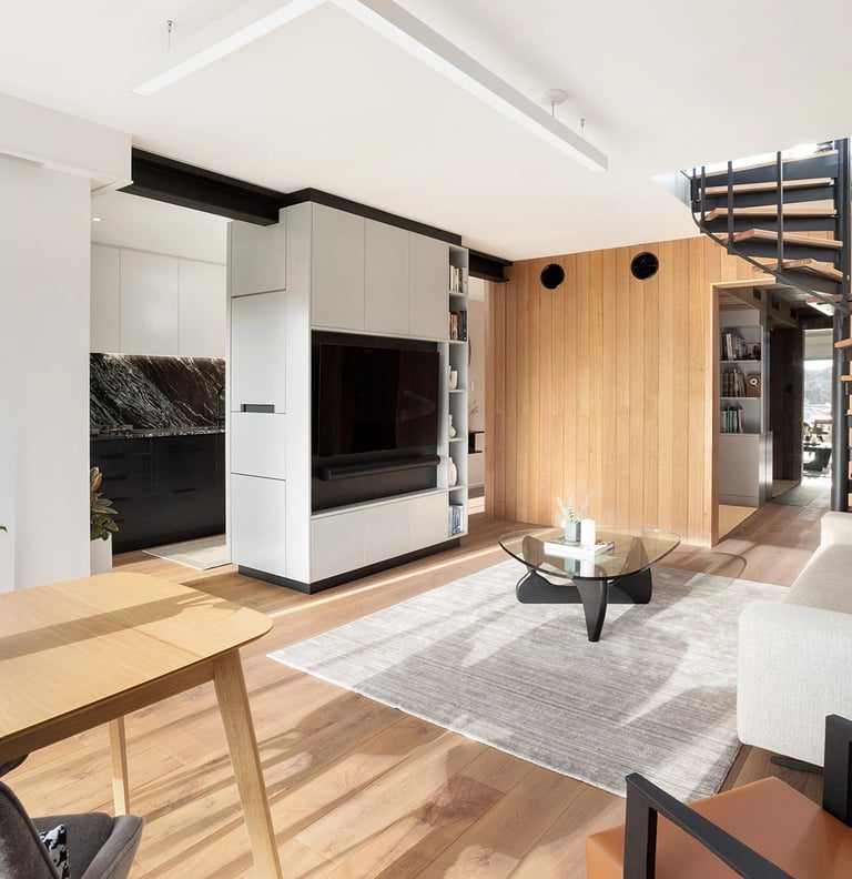 contemporary design of the renovated living room in Mosman Bay with central TV joinery cabinet and timber features