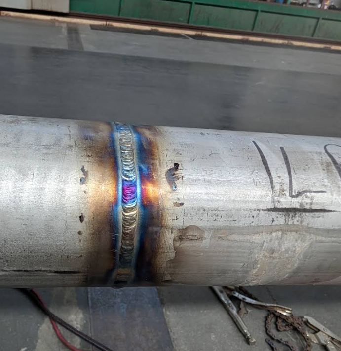 a metal pipe pipe with a blue flame on it