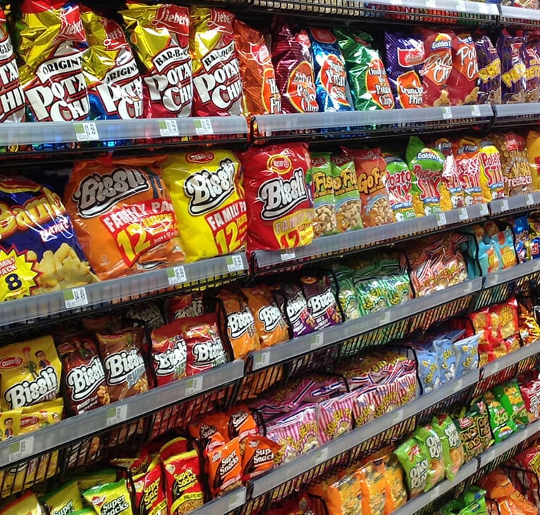 Various bags of chips on a gondola in a store