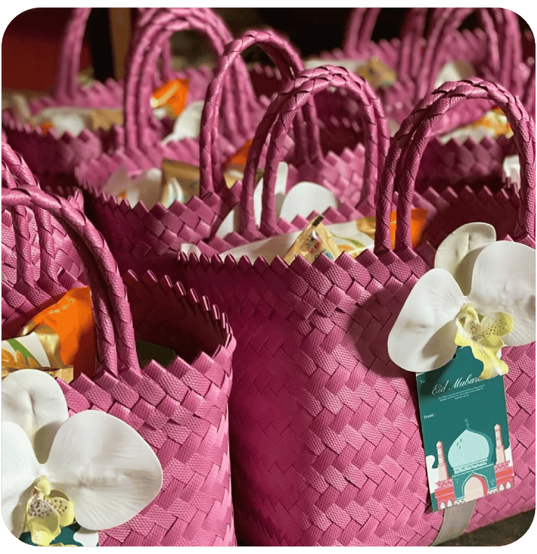 Pink handmade woven bag gift sets prepared for Eid celebration souvenirs.