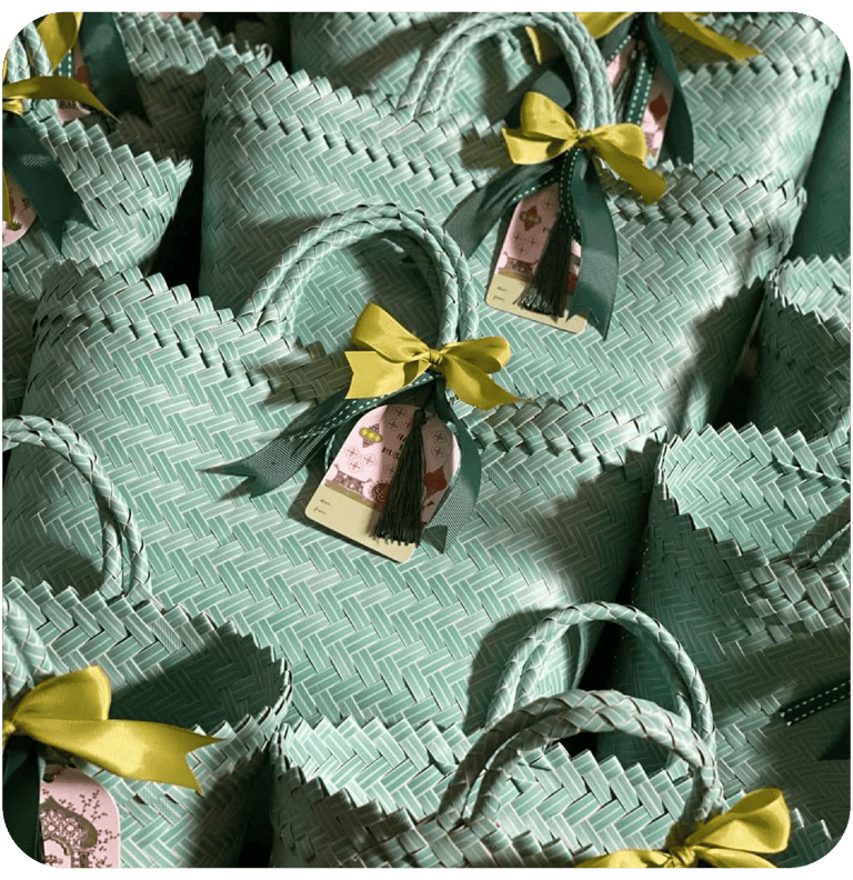 Custom mint green handmade woven bags prepared as corporate gift souvenirs.