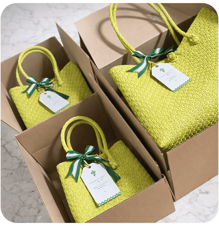 Handmade green woven plastic bags packed in boxes and prepared for wholesale shipping.