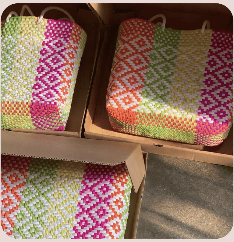 Colorful patterned woven plastic bags packed in boxes for bulk export and wholesale distribution.