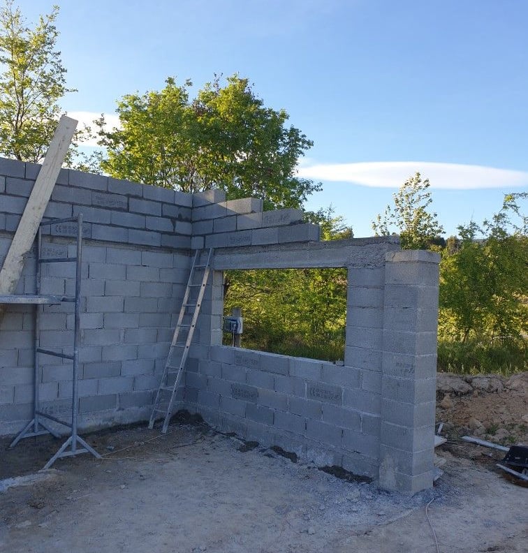 Construction en cours d’un mur en blocs de béton – maçonnerie pour extension ou nouvelle structure.