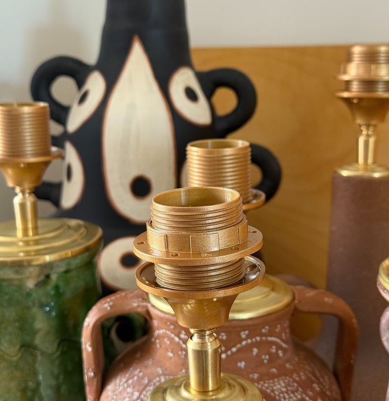Collection of vintage ceramic lamps and brass fixtures with artistic pottery bases.