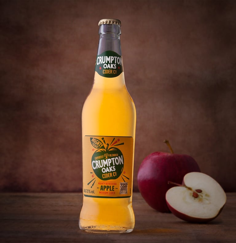 Bottle of Cider with apples in the background