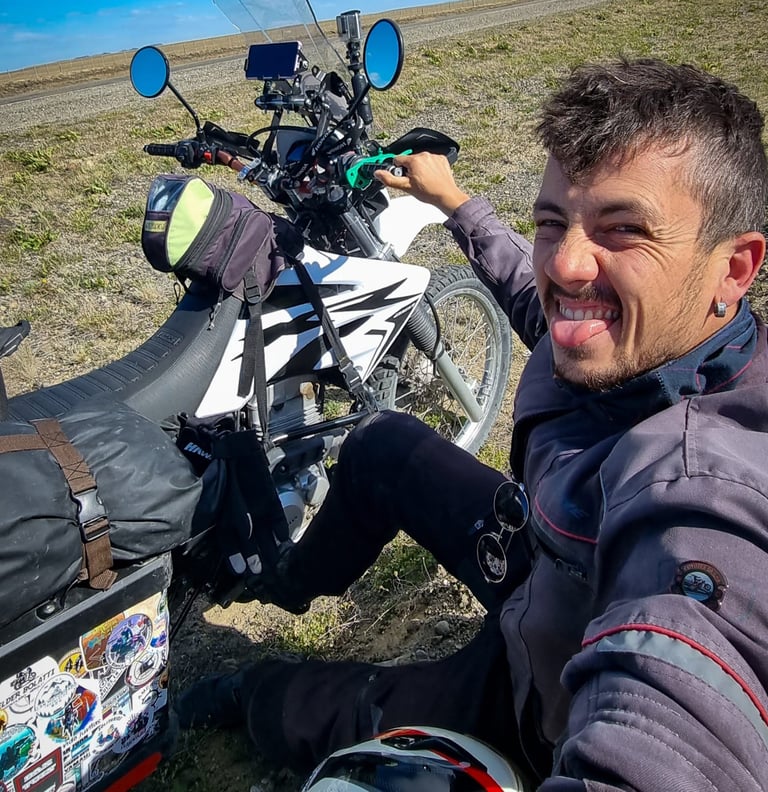 a man sitting on a motorcycle with a backpack on his back