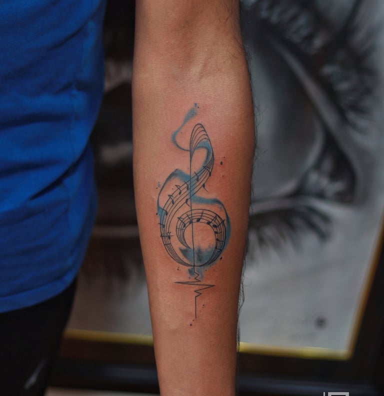 Watercolor music symbol tattoo at Dudo's Tattoos Hyderabad