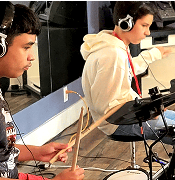Teens drumming on electric drums