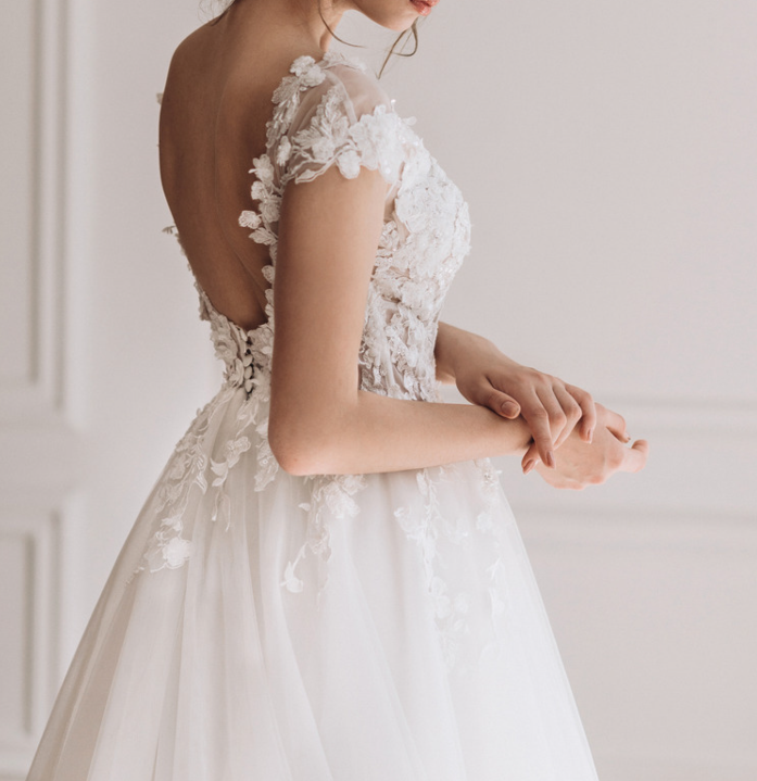 a woman in a wedding dress with a tiablet