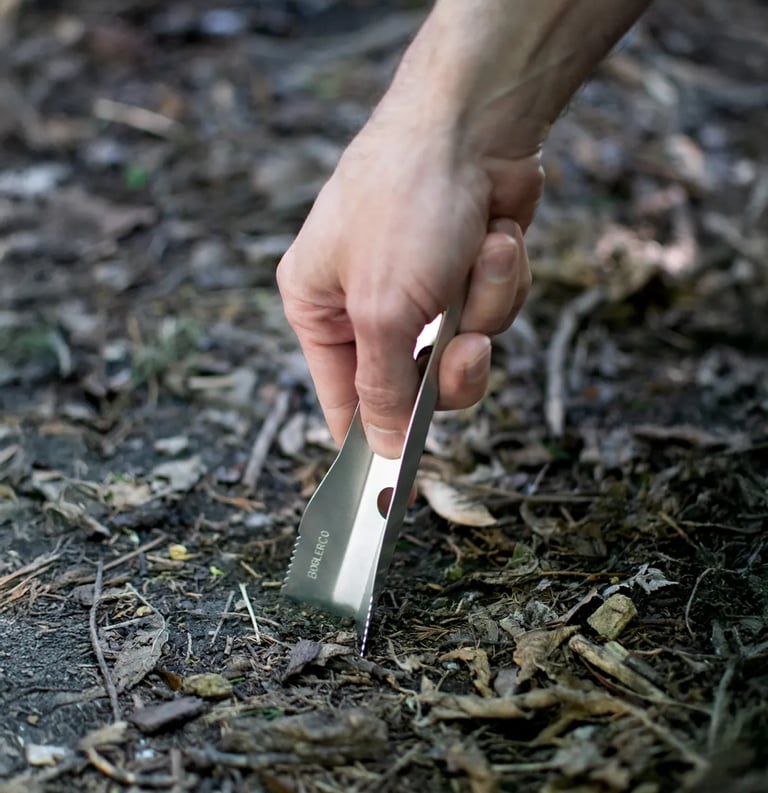 hand pushing boglerco trowel into ground