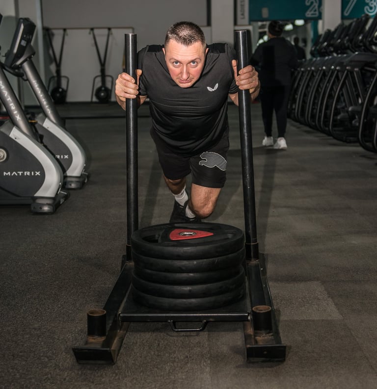 Trainer is doing a pull up barbell