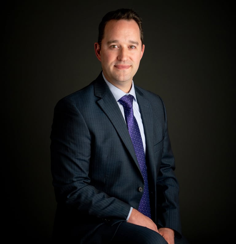 a man in a suit and tie posing for a portrait