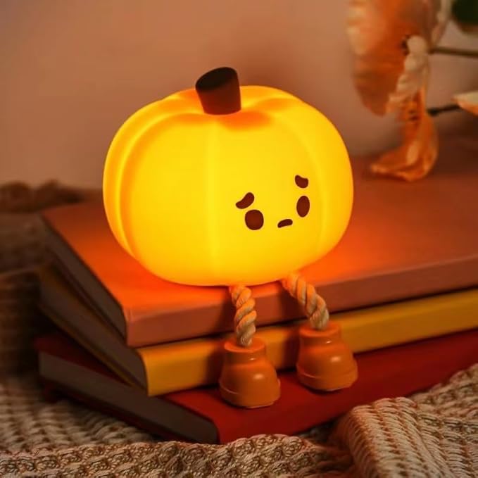 Pumpkin-shaped silicone LED night light, dimmable touch lamp for kids, bedside, and Halloween décor.