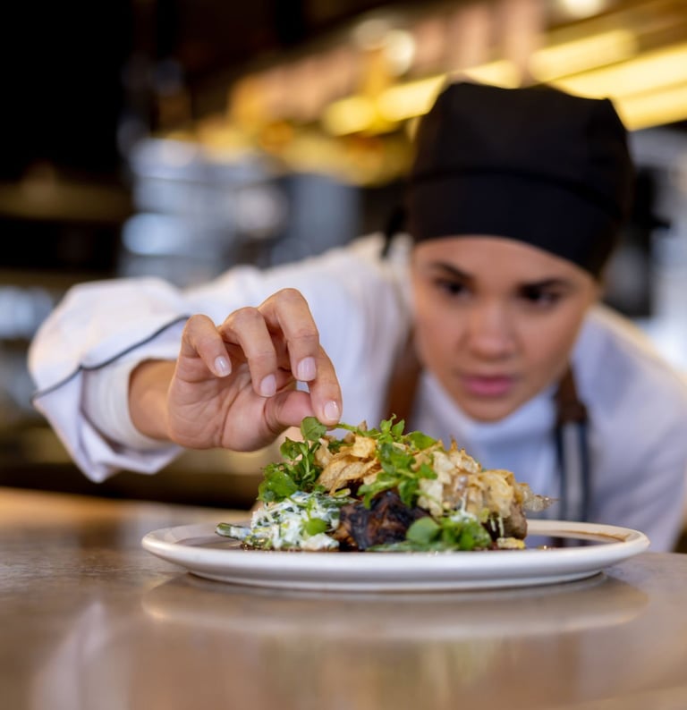 a chef is preparing to serve a meal