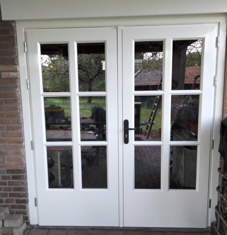 a white door with a brick wall and a brick wall