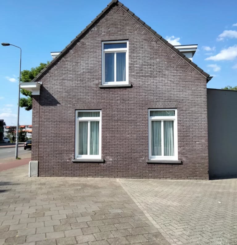 a house with a brick wall and a brick wall