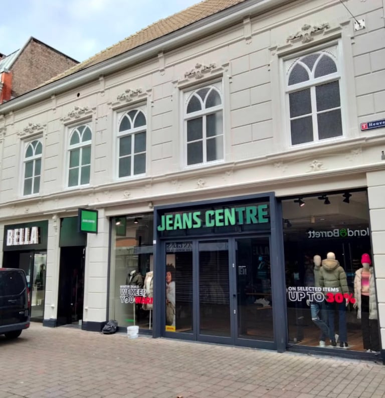a storefront of a storefront with a car parked in front of it
