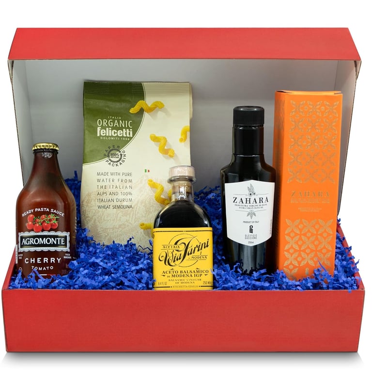 Gourmet Italian food gift basket in a red box featuring organic pasta, tomato sauce, and balsamic vinegar.