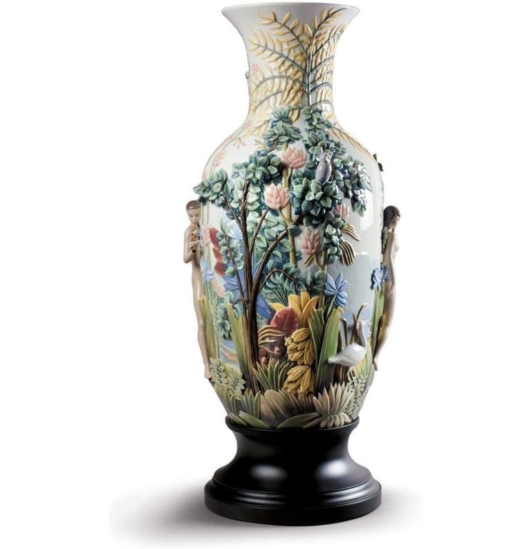 Ornate Lladró porcelain vase featuring a detailed tropical jungle relief with exotic flowers and figures.