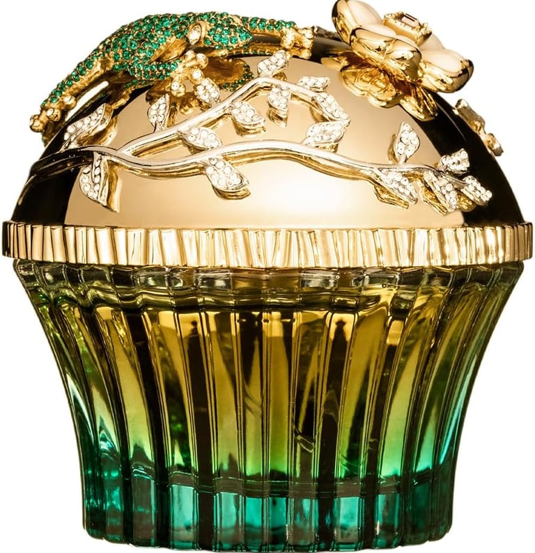 Luxury emerald cupcake perfume bottle featuring a gold lid with crystal lizard and floral accents.
