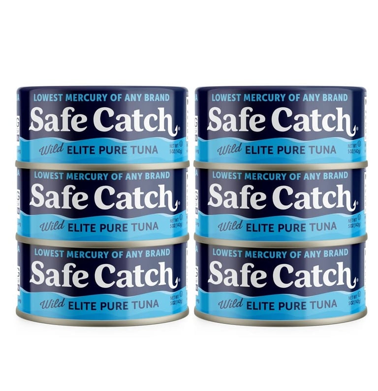 Six cans of Safe Catch Wild Elite Pure Tuna stacked against a white background.