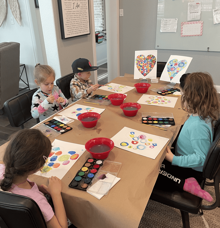 Young students working on watercolor circle paintings in Kelley’s Neighborhood Art class