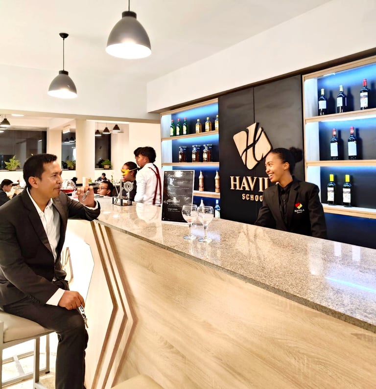 a man in a suit and tie is sitting at a bar