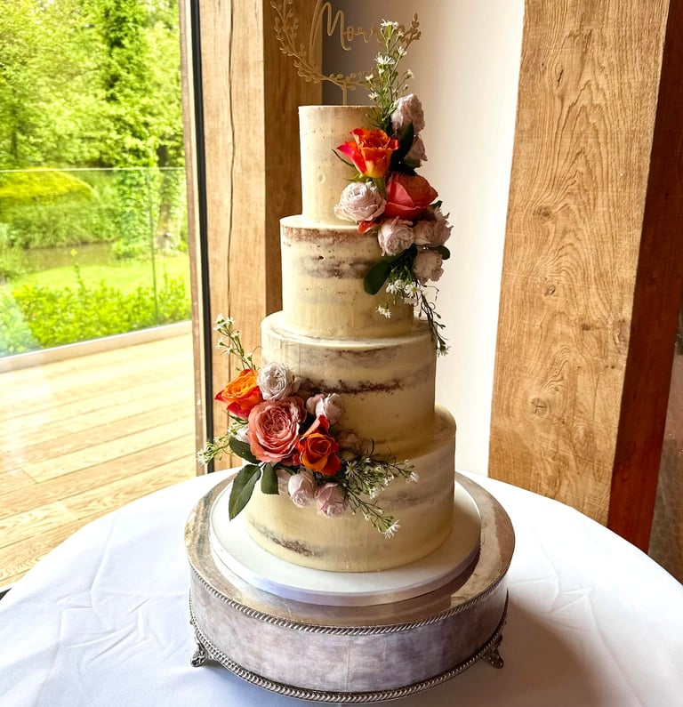 Semi Naked 4 tier Wedding cake with Fresh Flowers by Sweetcupcakes cakery