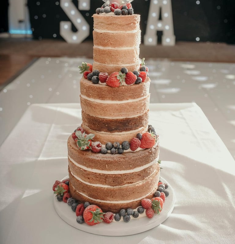 Naked 3 Tier Wedding Cake with Fresh Berries by Sweetcupcakes Cakery