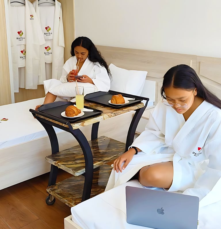 a woman sitting on a bed with a laptop computer