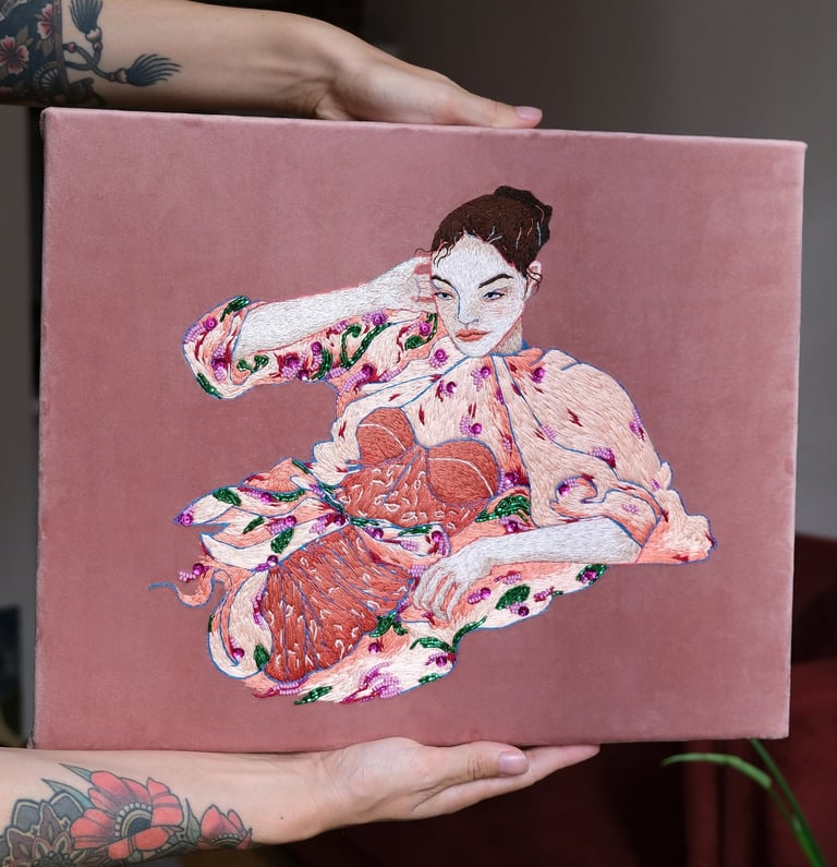 Embroidery of a fashion illustration with a women in pink dress