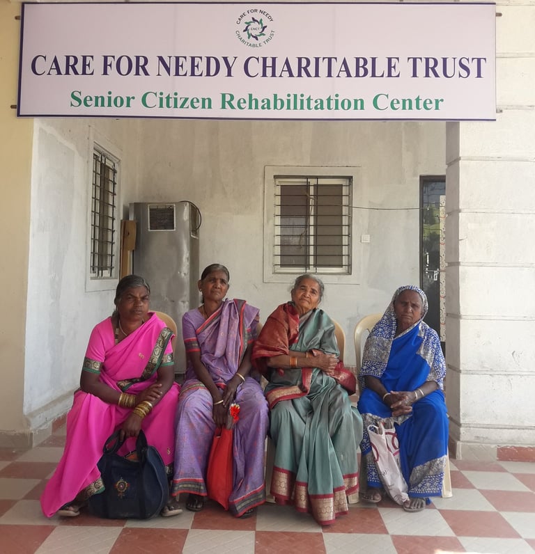 a group of women sitting on a bench in front of a sign