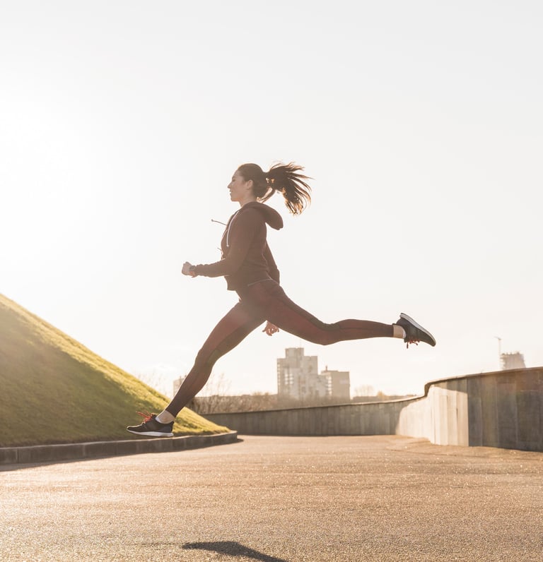 a woman is running in the sun