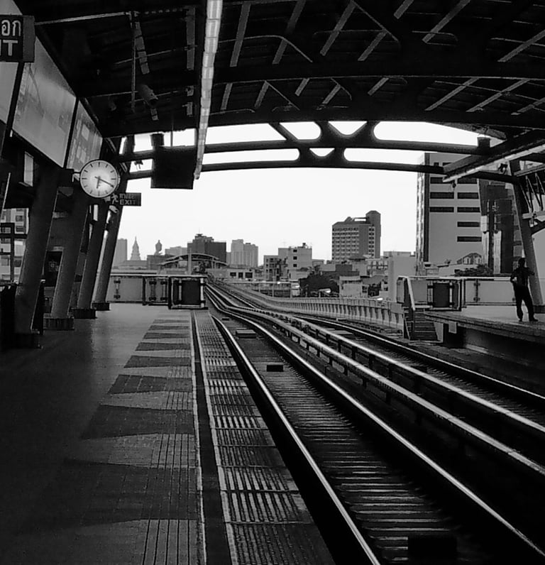 a train station with a train on the tracks