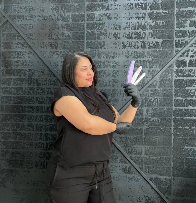 a woman in black top and gloves holding a purple hairbrush