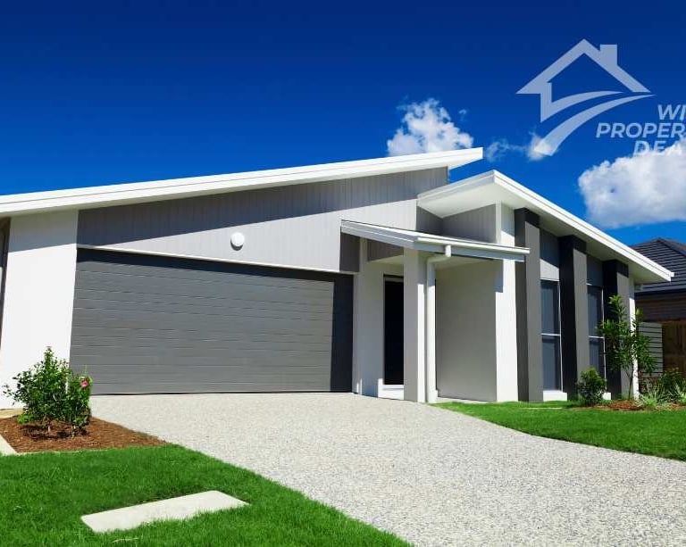 a house with a garage door and a driveway