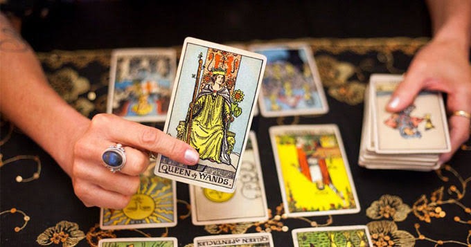 a person holding a tarot card game
