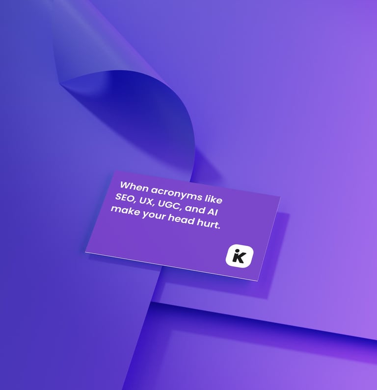 purple business card that reads "When acronyms like SEO, UX, UGC, and AI make your head hurt"
