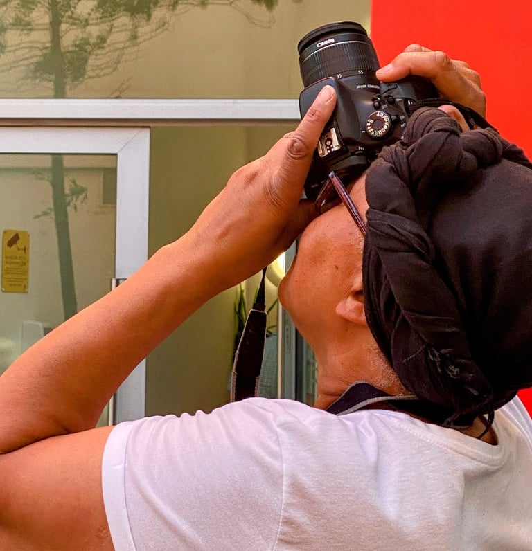 A workshop  participant taking photo of a building looking up