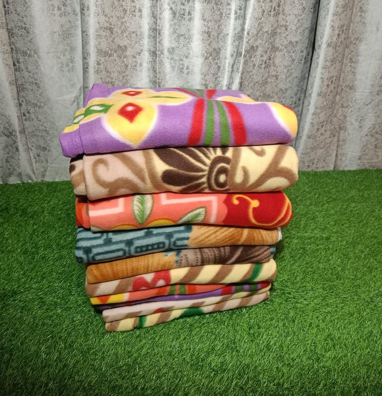 Wholesale premium fleece blankets by Rgl Textile Corporation, ideal for travel and NGO donations.