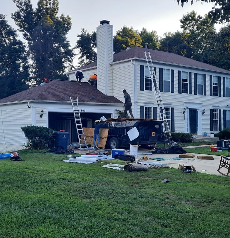 Roofing contractors working on a home in Northern Virginia providing roof replacement and repair services
