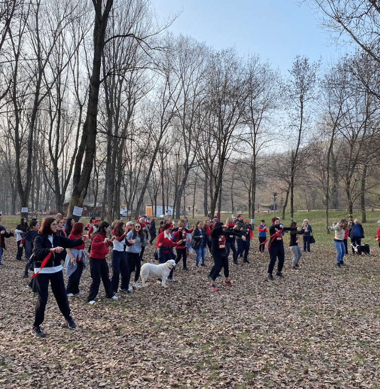 a group of people standing in a field with trees