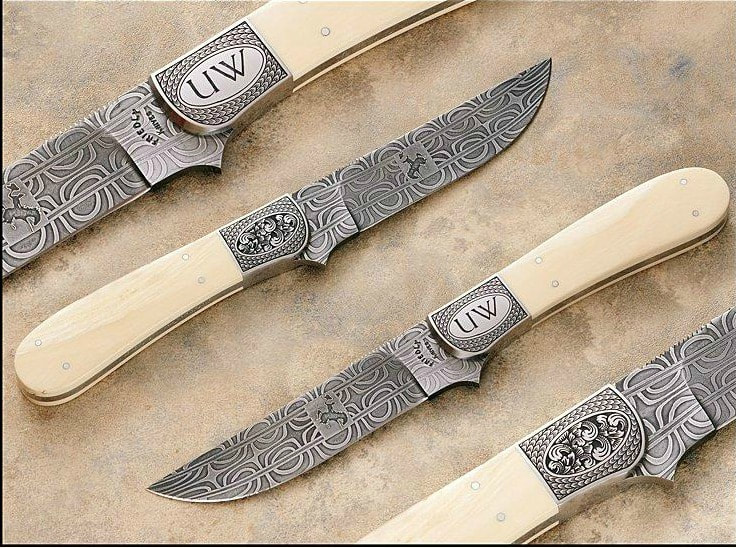 a group of custom engraved knives by Heritage Collectables