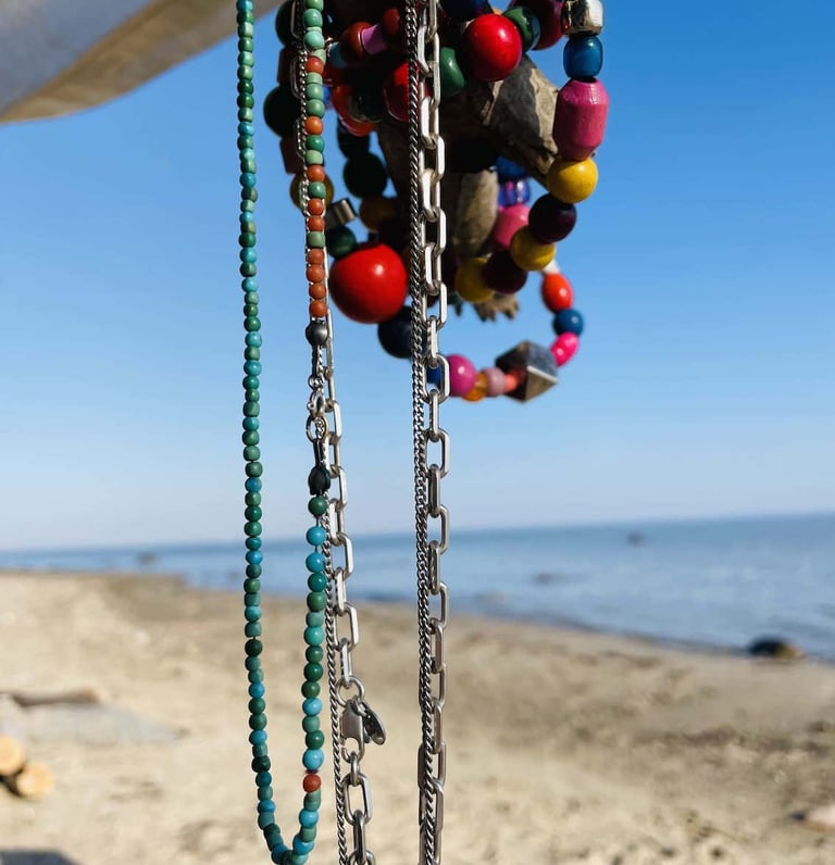 Handmade beaded necklaces at the beach.